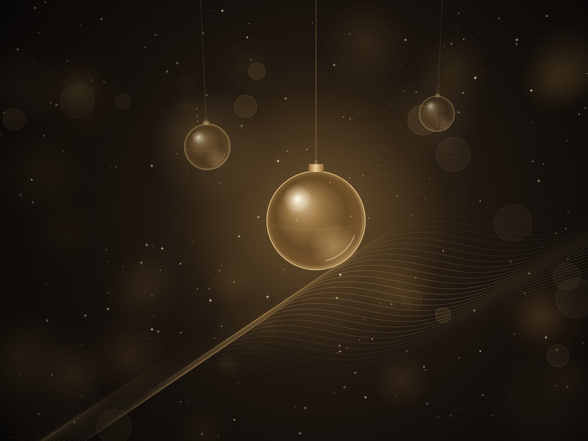 Gold glass baubles and soft lights on a dark background
